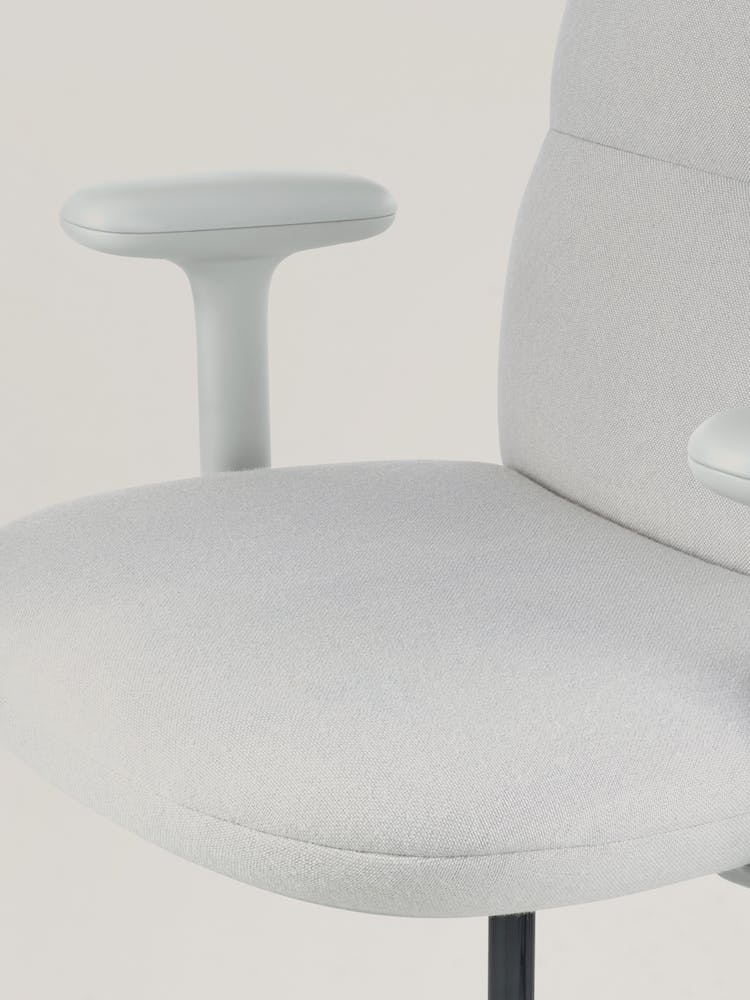 Närbild av en grå kontorsstol Asari från Herman Miller, som visar den konturerade sitsen.