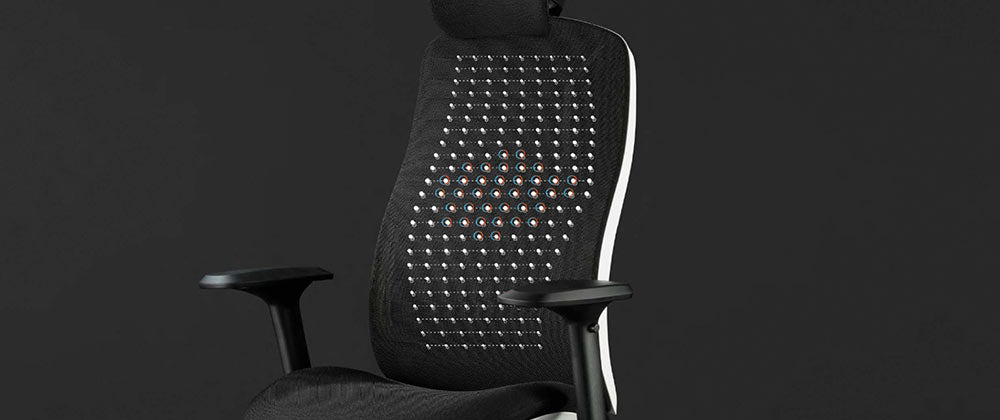 Framifrånvy av en vit och svart Vantum-gamingstol från Herman Miller, överlagrad med vit grafik som framhäver fjädringsmaterialet.